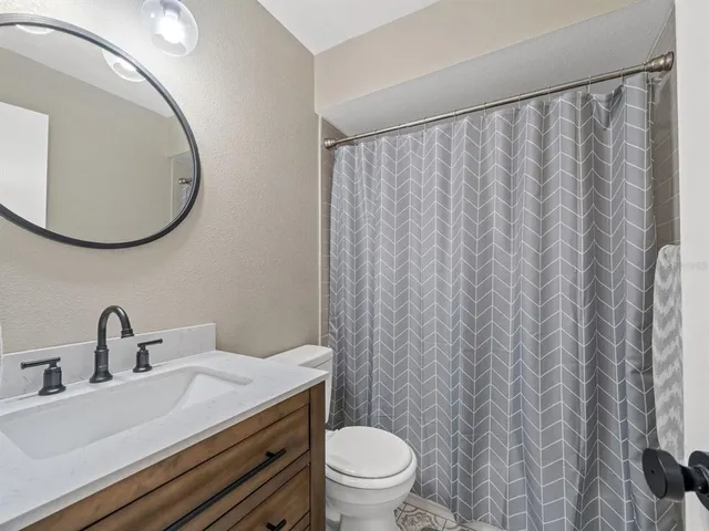 a bathroom with a toilet a sink and a mirror