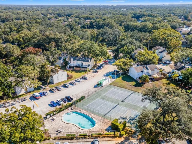 an aerial view of a house with a yard and lake view