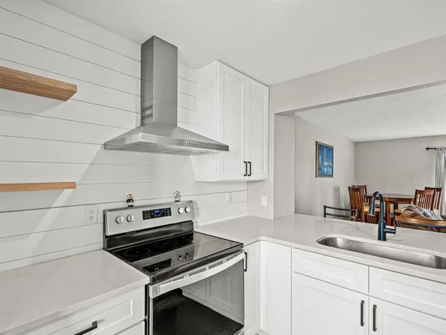 a kitchen with a sink and a stove top oven