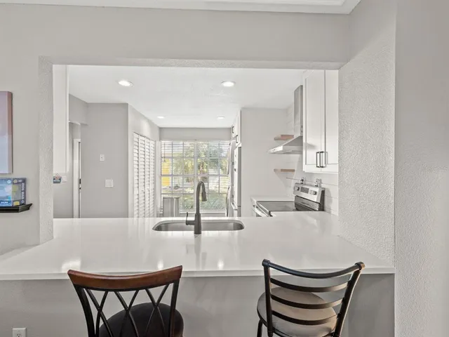 a view of a dining room with furniture and a large window
