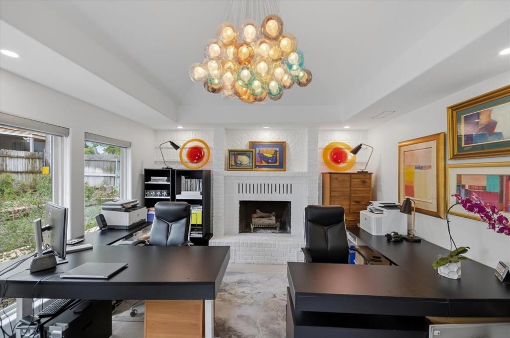 308 North Broadway Road Azle, TX 76020 - Photo 17 of 31 This spacious room features a white brick fireplace, multiple windows with views of the outdoor area, and a striking glass orb chandelier