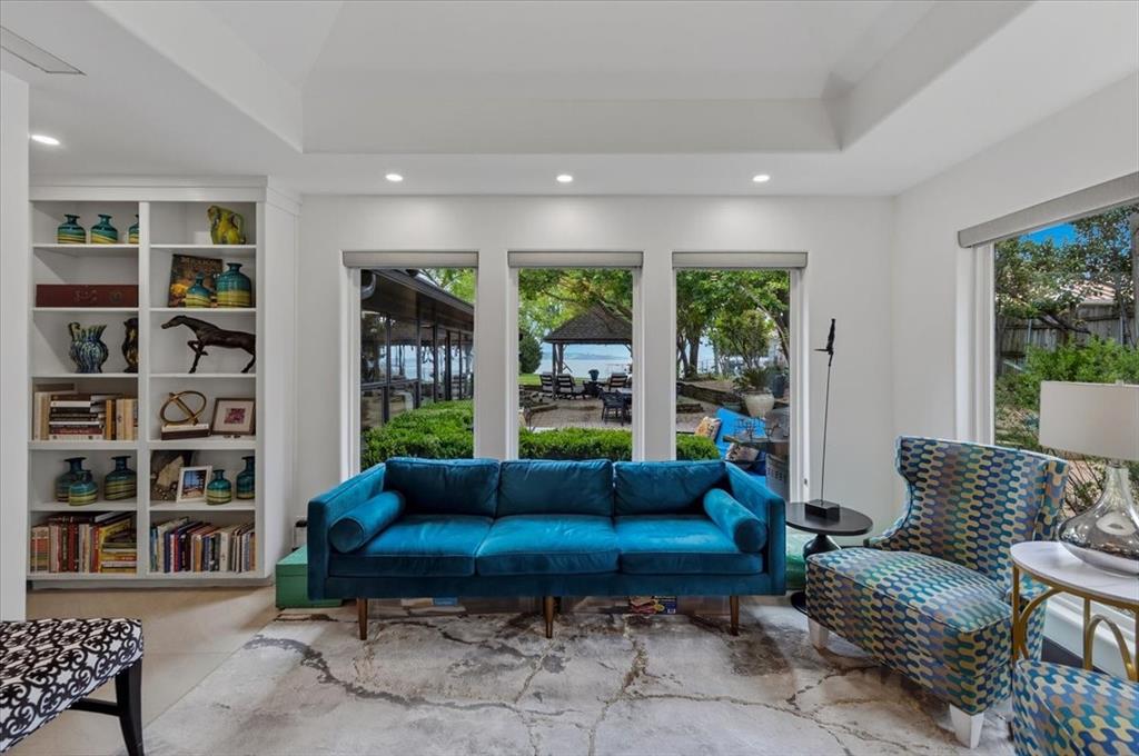308 North Broadway Road Azle, TX 76020 - Photo 18 of 31 Office area featuring built-in shelving, large windows with views of the outdoors, and a tray ceiling