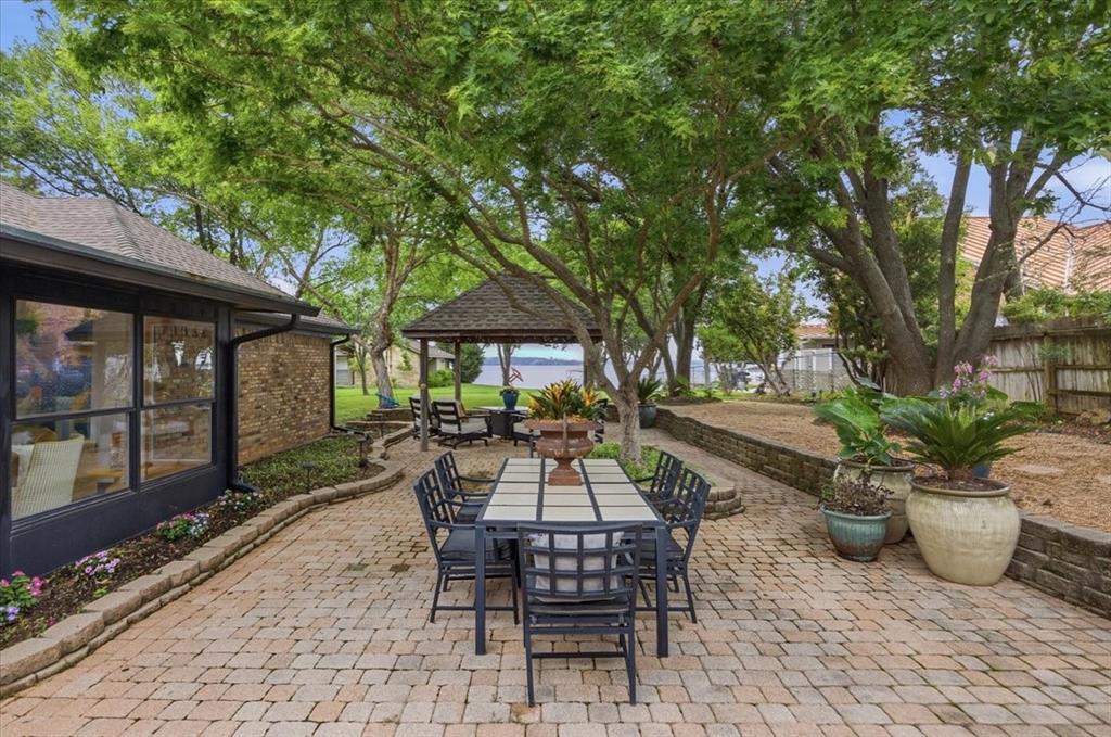 308 North Broadway Road Azle, TX 76020 - Photo 25 of 31 Expansive outdoor living area featuring a paved patio, mature trees, and a gazebo