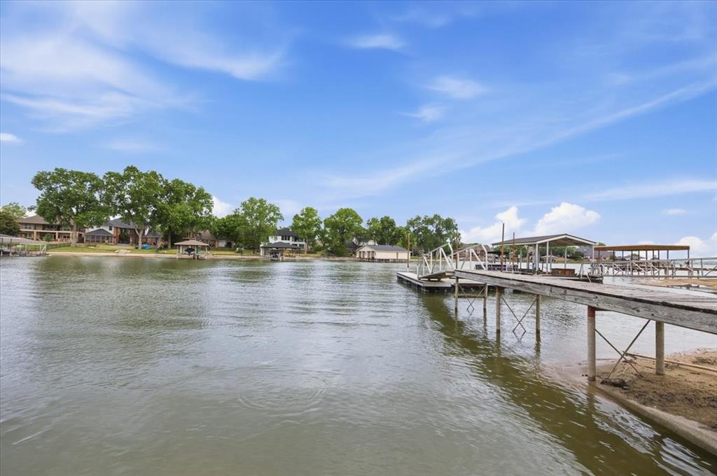 308 North Broadway Road Azle, TX 76020 - Photo 30 of 31 The property features a private dock with a covered boat slip, and boat launch ramp, providing direct water access