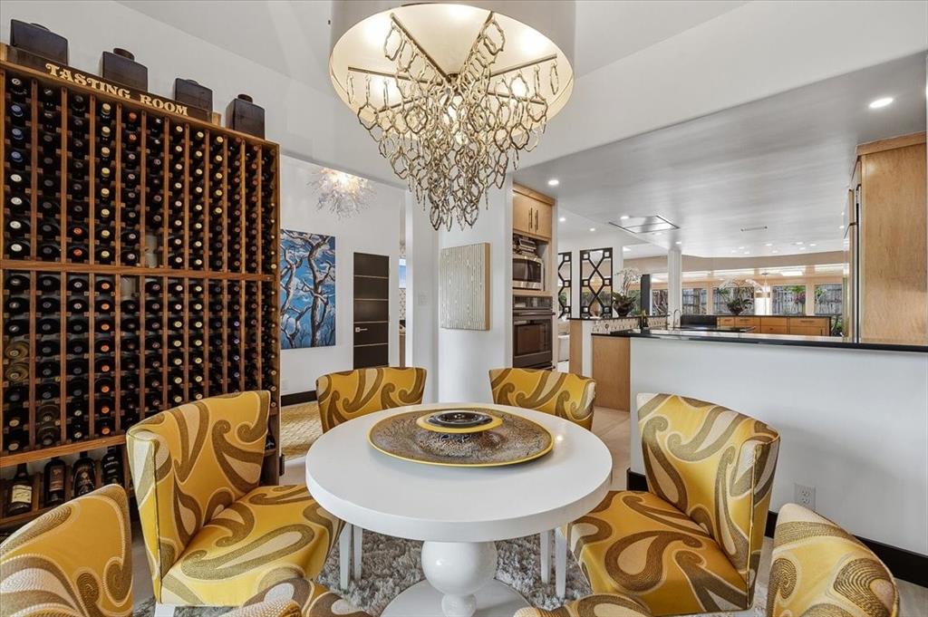 308 North Broadway Road Azle, TX 76020 - Photo 5 of 31 Dining area featuring a decorative chandelier, a round table, and a built-in wine rack