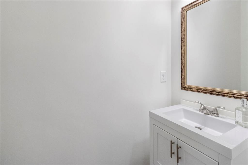 5437 Maple Grv Lane Flowery Branch, GA 30542 - Photo 11 of 27 a bathroom with a sink and a mirror