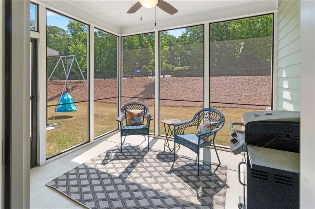 5437 Maple Grv Lane Flowery Branch, GA 30542 - Photo 12 of 27 a living room with a large window and chairs