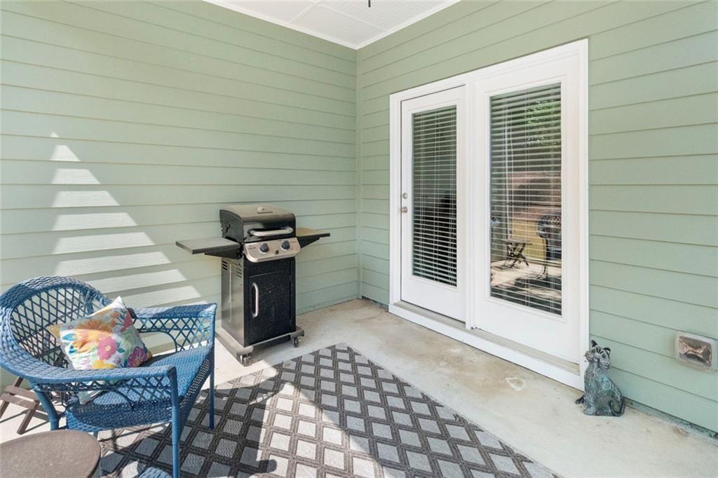 5437 Maple Grv Lane Flowery Branch, GA 30542 - Photo 13 of 27 a view of a patio with table and chairs and potted plants