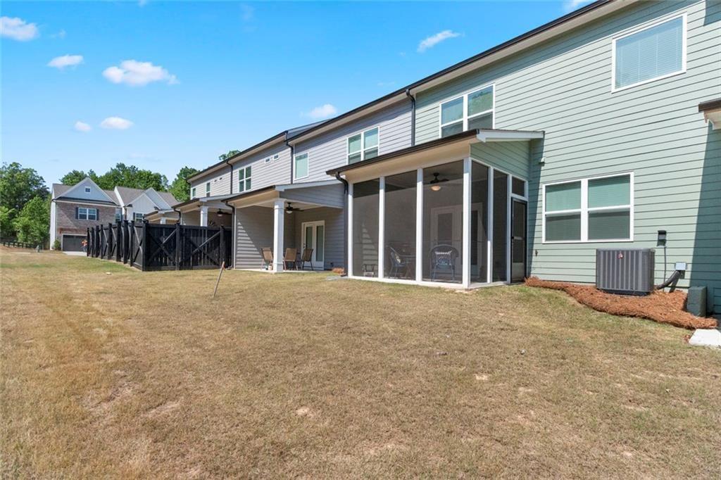 5437 Maple Grv Lane Flowery Branch, GA 30542 - Photo 15 of 27 a view of a house with a patio and a yard