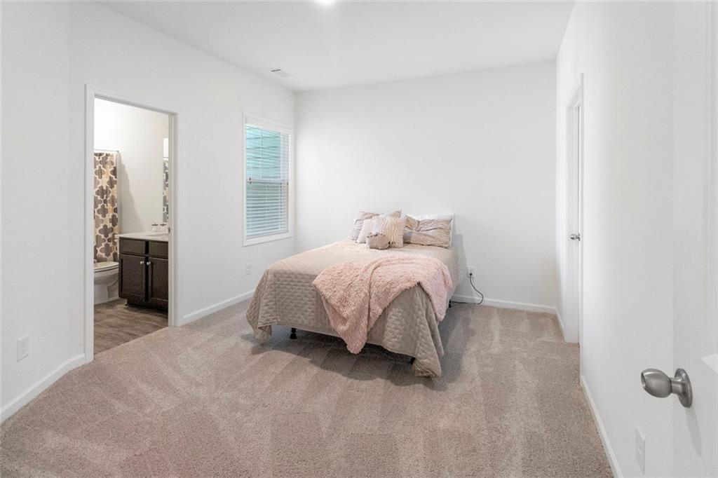 5437 Maple Grv Lane Flowery Branch, GA 30542 - Photo 18 of 27 a bedroom with a bed and a window
