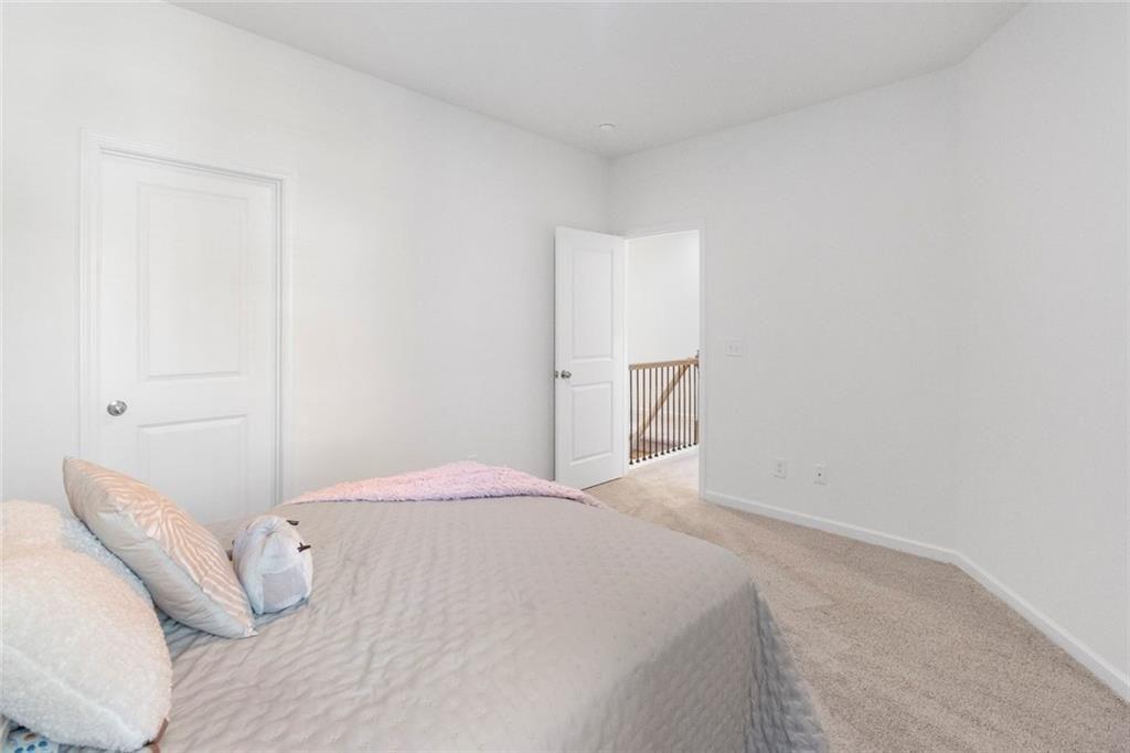 5437 Maple Grv Lane Flowery Branch, GA 30542 - Photo 19 of 27 a bedroom with a bed and pillows