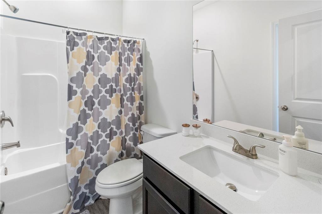 5437 Maple Grv Lane Flowery Branch, GA 30542 - Photo 20 of 27 a bathroom with a sink toilet and shower