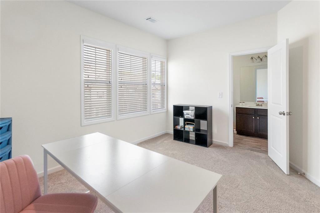 5437 Maple Grv Lane Flowery Branch, GA 30542 - Photo 21 of 27 a living room with furniture and large window