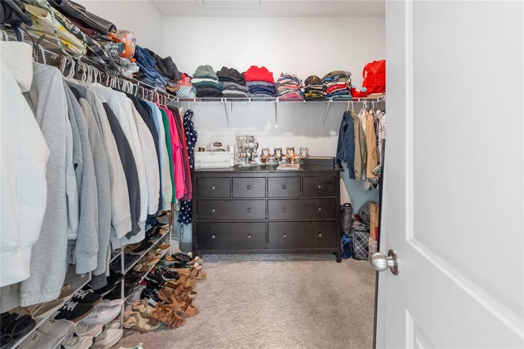 5437 Maple Grv Lane Flowery Branch, GA 30542 - Photo 27 of 27 a view of walk in closet with clothes