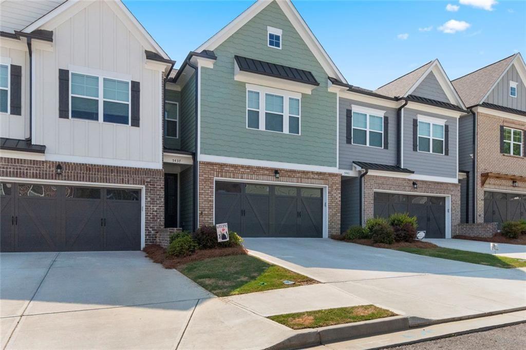 5437 Maple Grv Lane Flowery Branch, GA 30542 - Photo 3 of 27 a front view of a house with a yard and garage