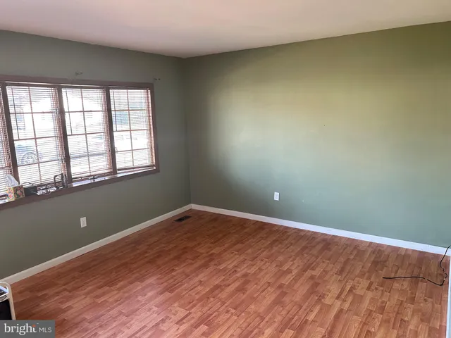 a view of a room with wooden floor and closet