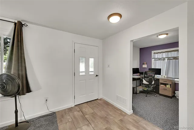 a view of a livingroom with furniture and a window