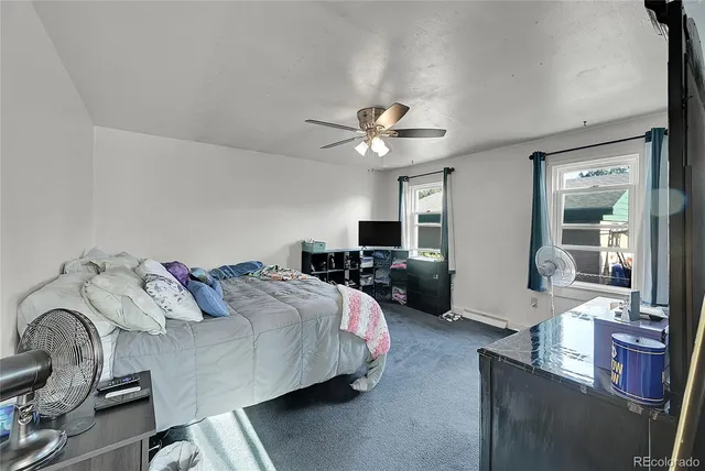 a bedroom with a bed couch and a window