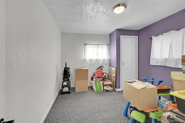 a living room with furniture and a lamp