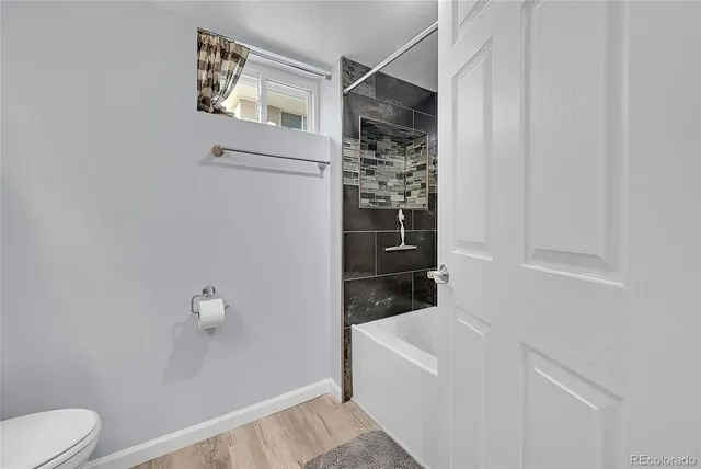 a bathroom with a bathtub and toilet