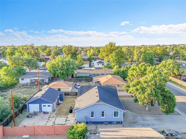an aerial view of residential houses with outdoor space