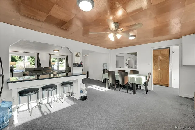 a view of a dining room with furniture and chandelier