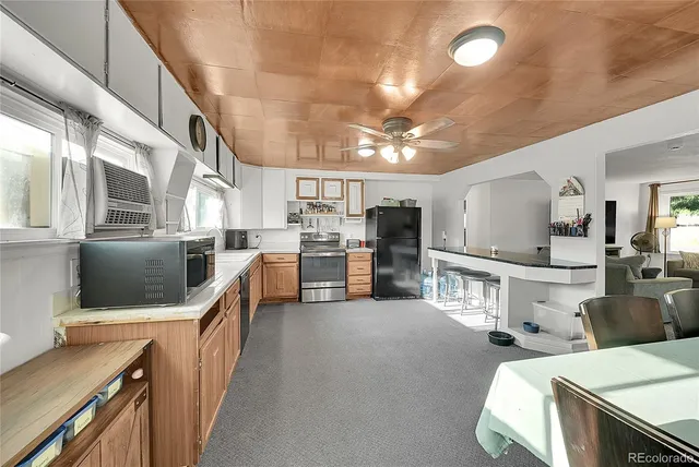 a kitchen with stainless steel appliances kitchen island granite countertop a sink and counter space