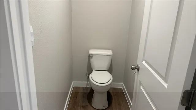 a white toilet sitting in a bathroom