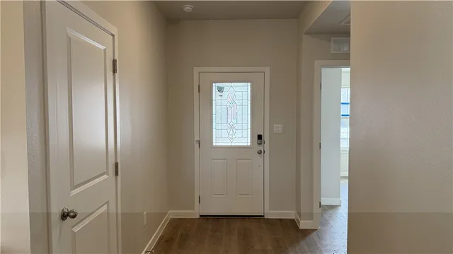 a view of front door with wooden floor