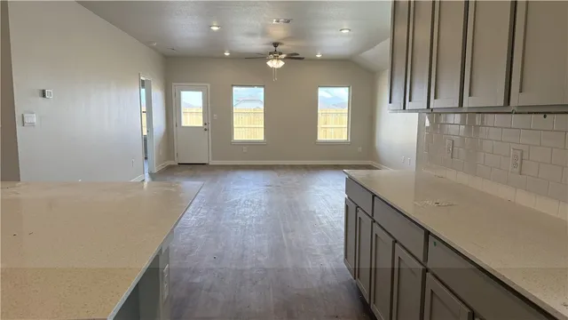 a view of a kitchen with kitchen appliances and cabinets