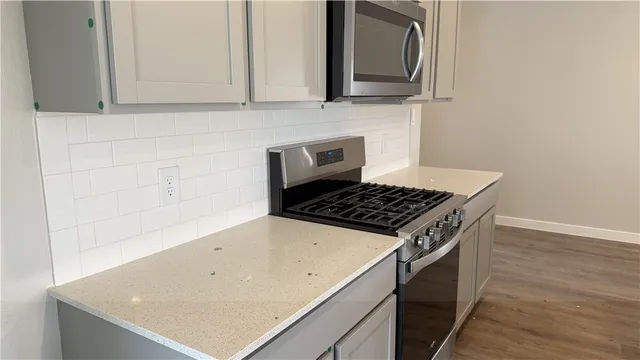 a kitchen with wooden cabinets and a stove top oven