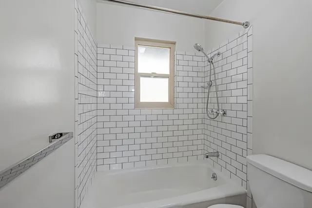 a bathroom with a bathtub and shower