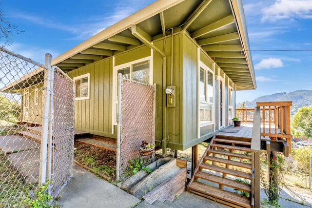 a front view of a house with wooden floor and windows