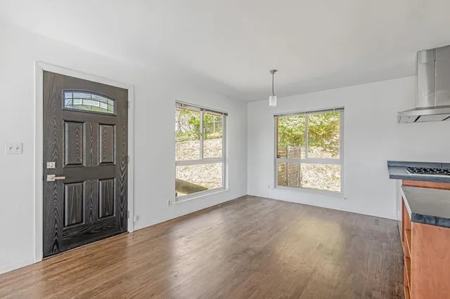 an empty room with windows lake and mountain view