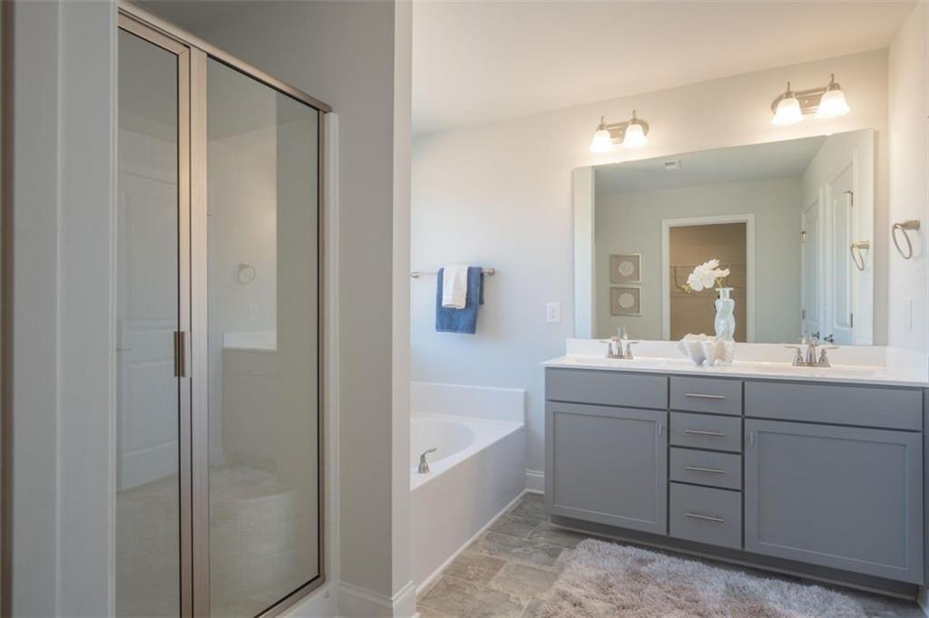 668 Bald Ridge Circle Demorest, GA 30535 - Photo 15 of 21 a bathroom with a bathtub sink vanity and mirror