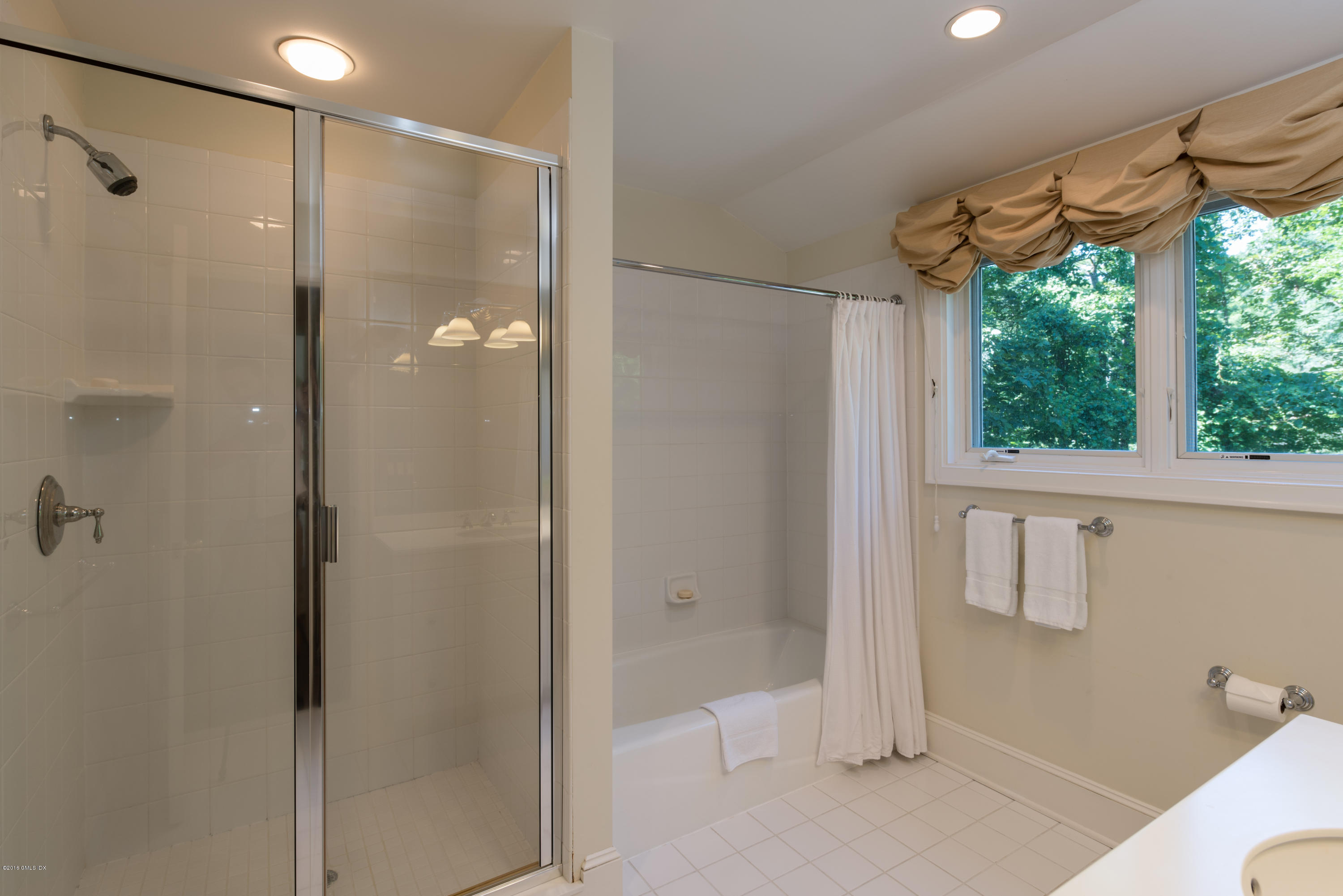 27 Mooreland Road Greenwich, CT 06831 - Photo 19 of 21 a bathroom with a shower and a bathtub