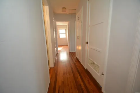 a view of a room with wooden floor