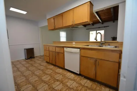 a kitchen with a sink cabinets and stainless steel appliances