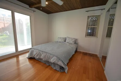a bed sitting in a bedroom next to a window