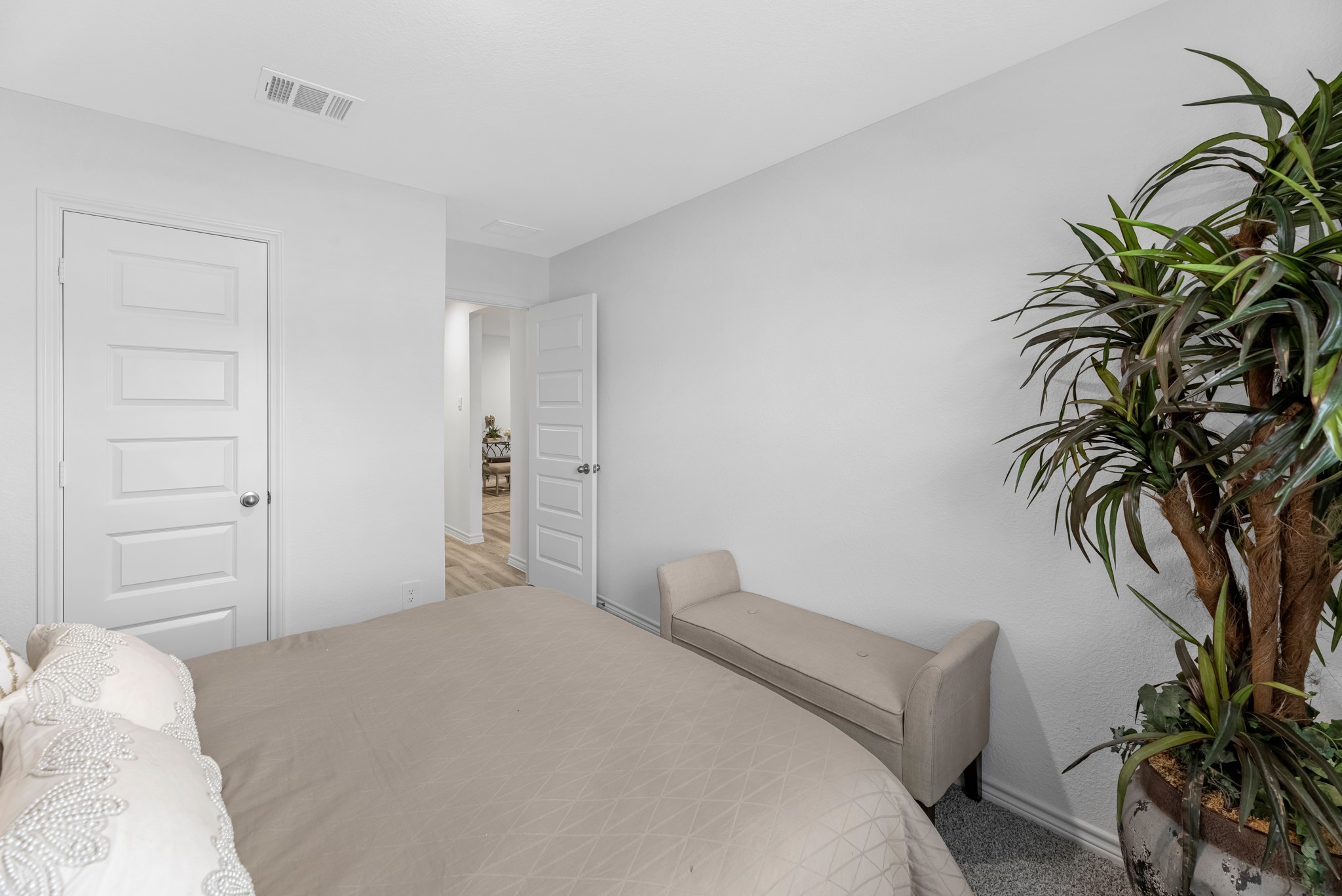 5655 Spoonbill Lane Orange, TX 77632 - Photo 11 of 23 a bedroom with a bed and a potted plant