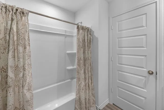 a bathroom with a shower and a tub