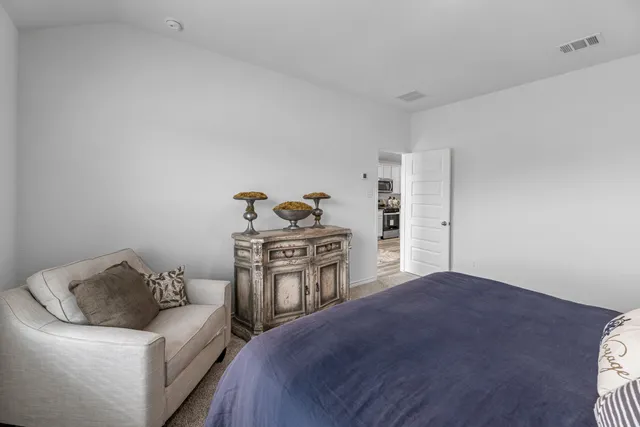 a bedroom with a bed and a dresser