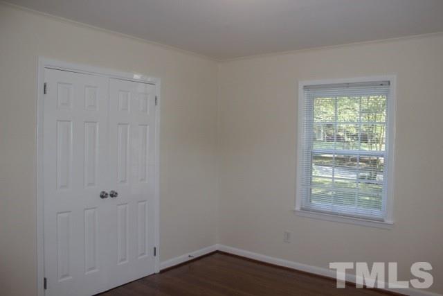 800 Friar Tuck Road Raleigh, NC 27610 - Photo 15 of 18 a view of an empty room with wooden floor and a window