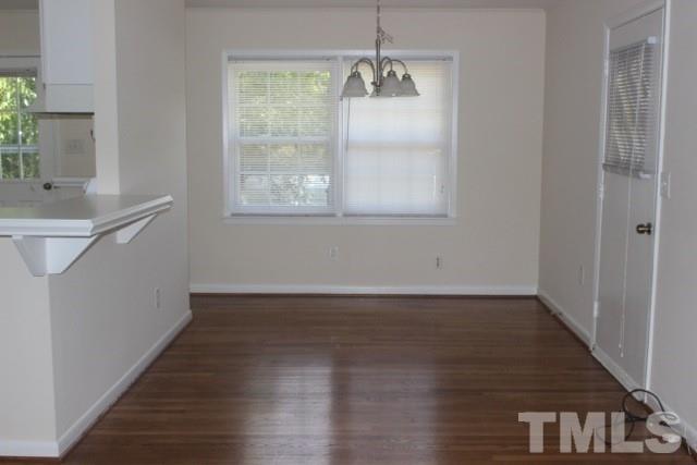 800 Friar Tuck Road Raleigh, NC 27610 - Photo 3 of 18 a view of an empty room with wooden floor and a window