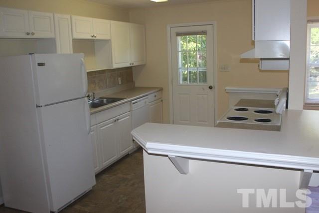 800 Friar Tuck Road Raleigh, NC 27610 - Photo 6 of 18 a kitchen with a refrigerator and a stove