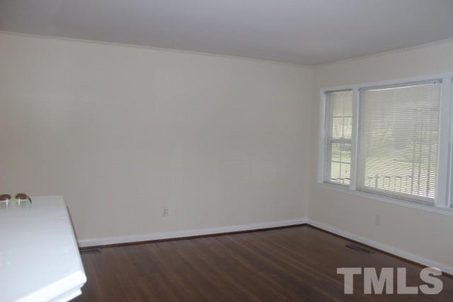 800 Friar Tuck Road Raleigh, NC 27610 - Photo 8 of 18 an empty room with wooden floor and windows