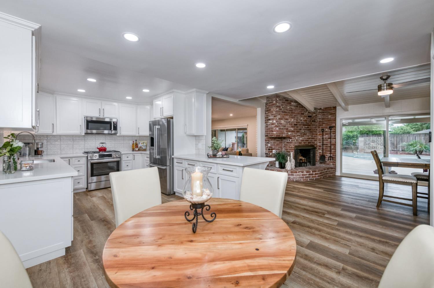 1540 West San Ramon Avenue Fresno, CA 93711 - Photo 18 of 32 a living room with furniture and a dining table with kitchen view