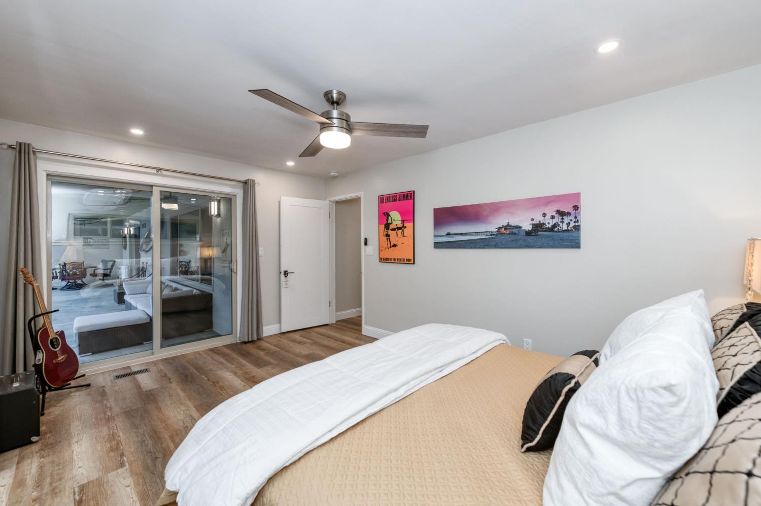 1540 West San Ramon Avenue Fresno, CA 93711 - Photo 23 of 32 a bedroom with a large bed and a chandelier