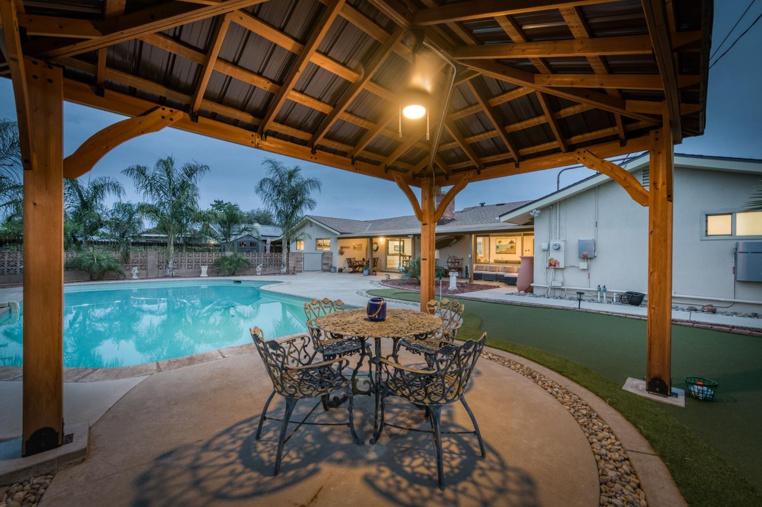 1540 West San Ramon Avenue Fresno, CA 93711 - Photo 31 of 32 a patio with table and chairs and potted plants