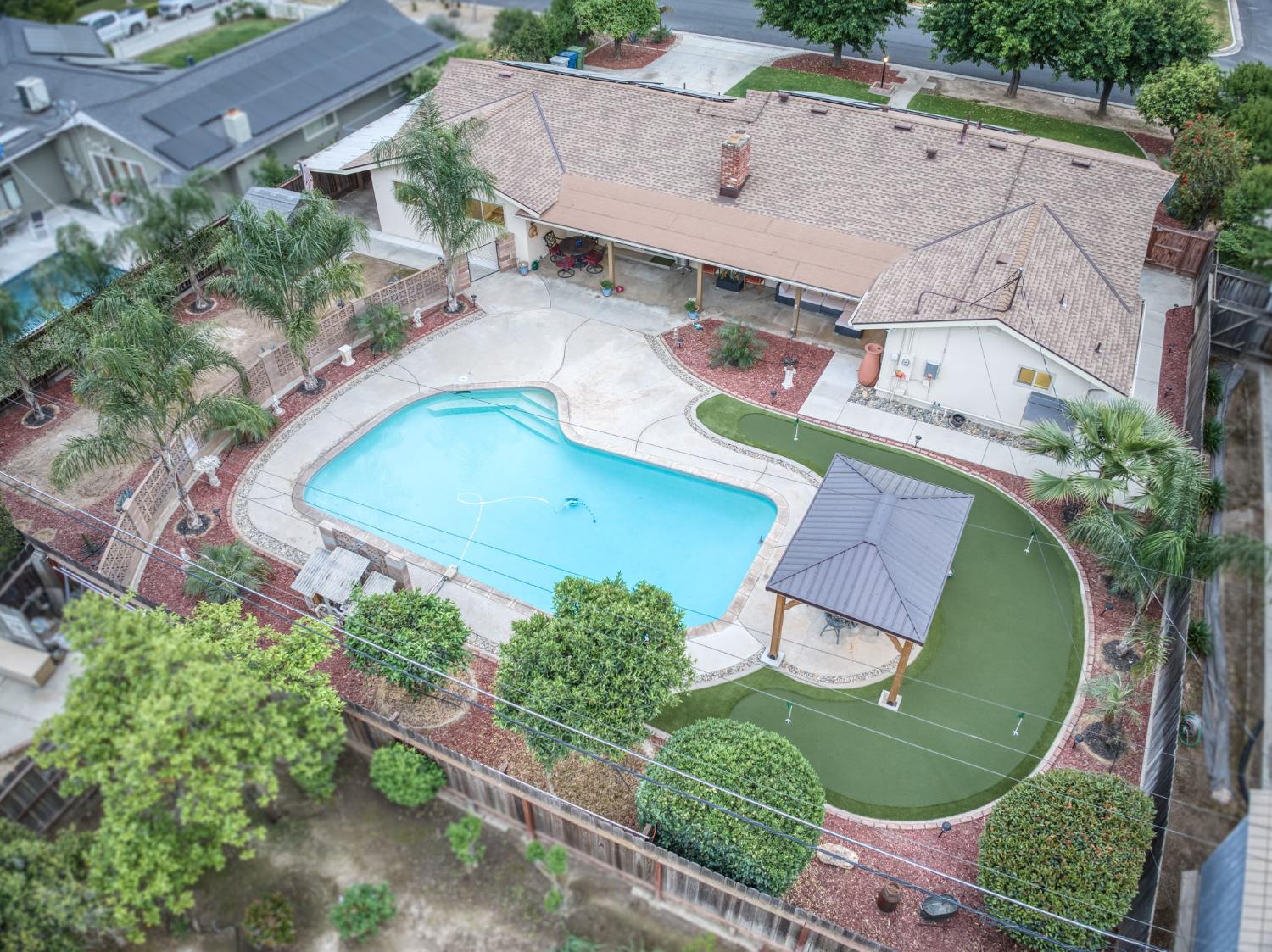 1540 West San Ramon Avenue Fresno, CA 93711 - Photo 32 of 32 an aerial view of a house with a swimming pool